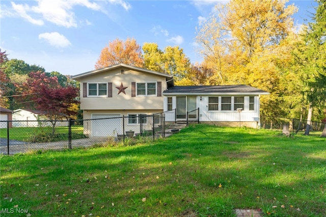 rear view of property with a lawn