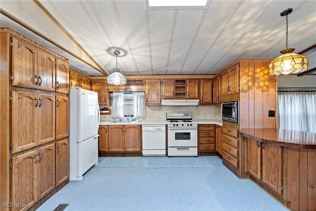 kitchen with pendant lighting, white appliances, light carpet, sink, and a healthy amount of sunlight