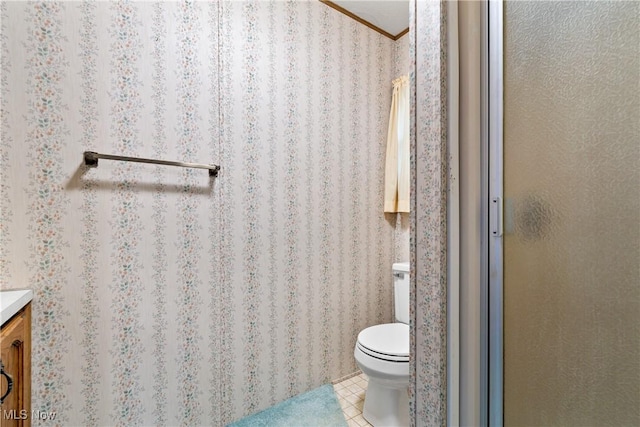 bathroom featuring tile patterned floors, vanity, toilet, and an enclosed shower