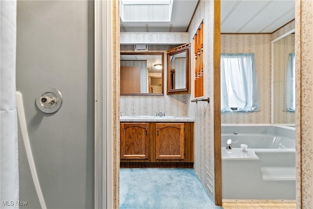 bathroom featuring a washtub and vanity