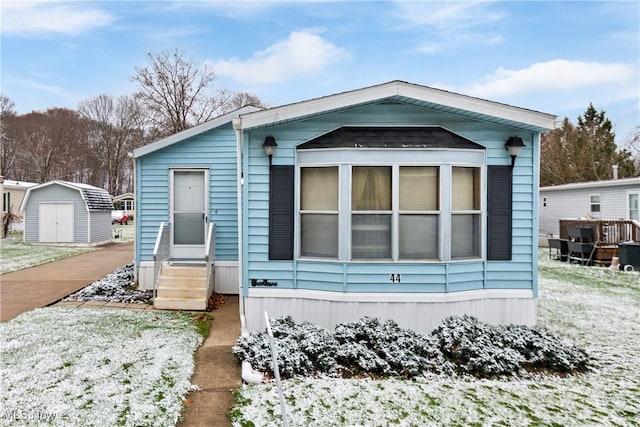 view of front of house featuring a storage unit