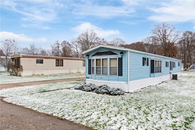 view of snow covered exterior with central AC