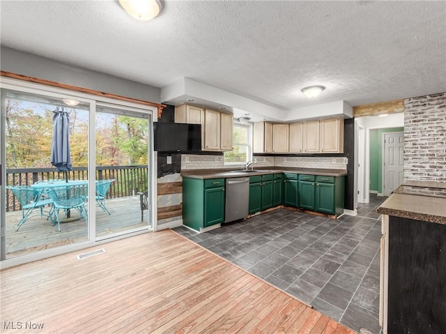 3905 E Greenwood, Zanesville, OH 43701 - kitchen featuring green cabinets, stainless steel dishwasher, a sink, a textured ceiling, and backsplash