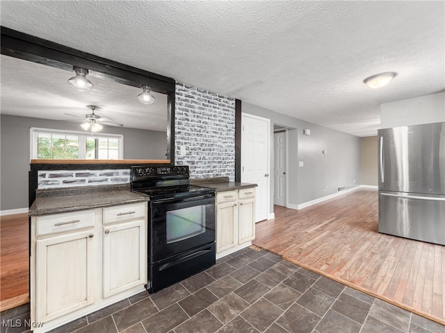 kitchen with electric range, dark hardwood / wood-style flooring, ceiling fan, a textured ceiling, and stainless steel refrigerator