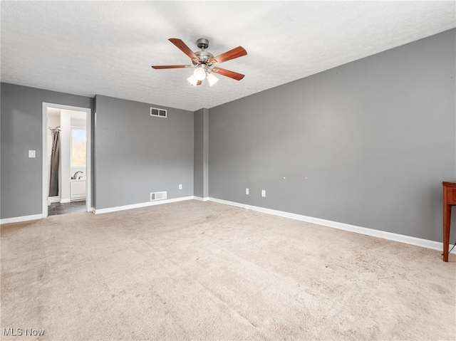 interior space with carpet flooring, a textured ceiling, and ceiling fan