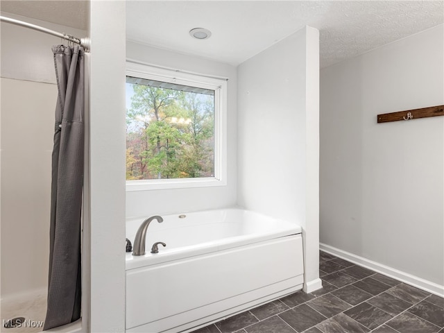 bathroom with a textured ceiling and plus walk in shower