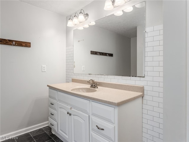 bathroom featuring vanity, a textured ceiling, tile patterned floors, and tile walls