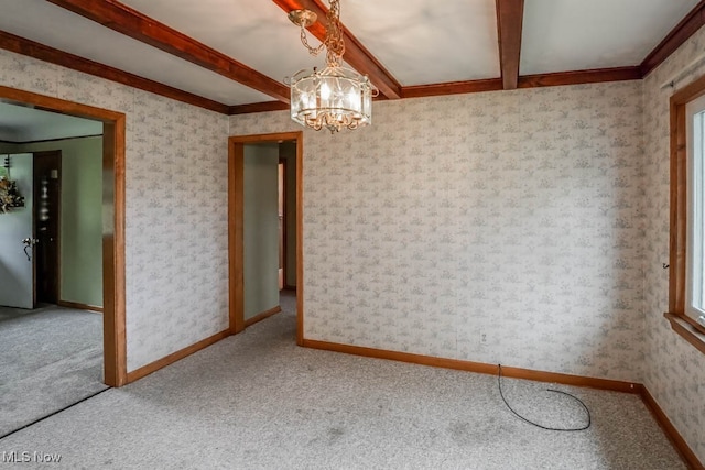 carpeted spare room featuring beam ceiling, crown molding, and a notable chandelier