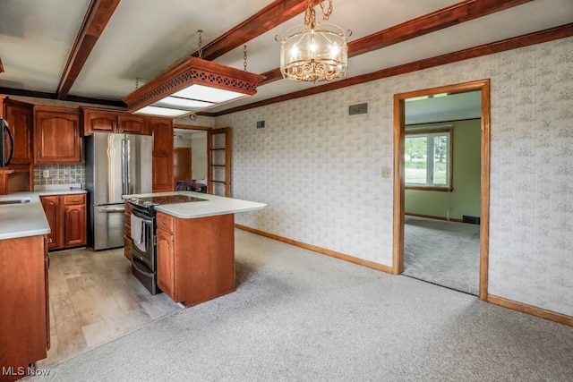 kitchen with beam ceiling, an island with sink, black range with electric cooktop, pendant lighting, and stainless steel refrigerator