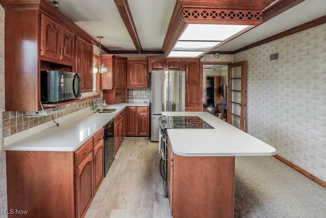 kitchen featuring beam ceiling, black appliances, sink, light hardwood / wood-style floors, and decorative light fixtures