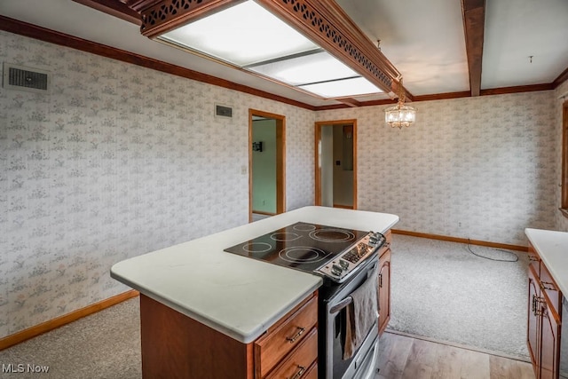 kitchen featuring beam ceiling, crown molding, stainless steel electric range, and pendant lighting