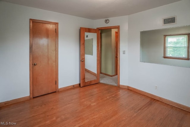 unfurnished bedroom featuring light wood-type flooring