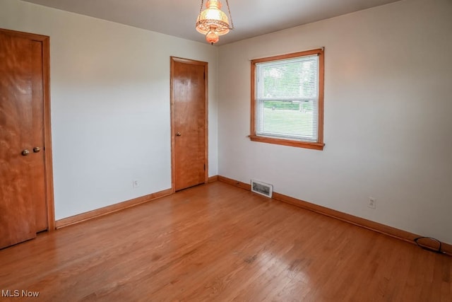 unfurnished room featuring light wood-type flooring