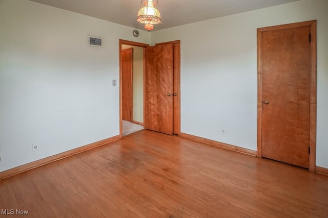 spare room featuring light hardwood / wood-style flooring