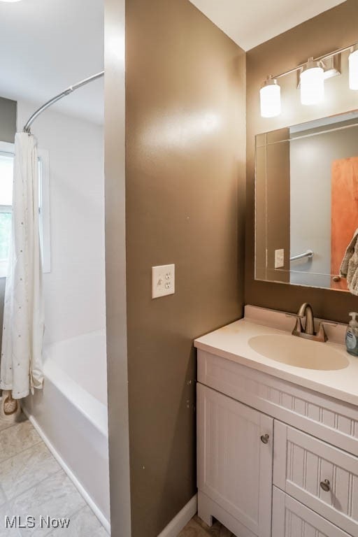 bathroom featuring vanity and shower / tub combo with curtain