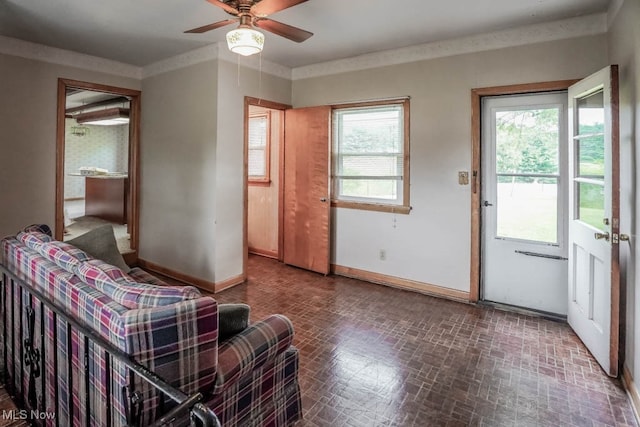 interior space with crown molding and ceiling fan