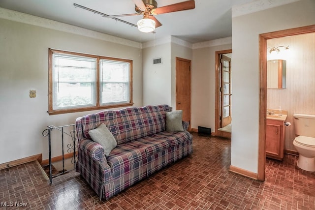 living room featuring ceiling fan and sink