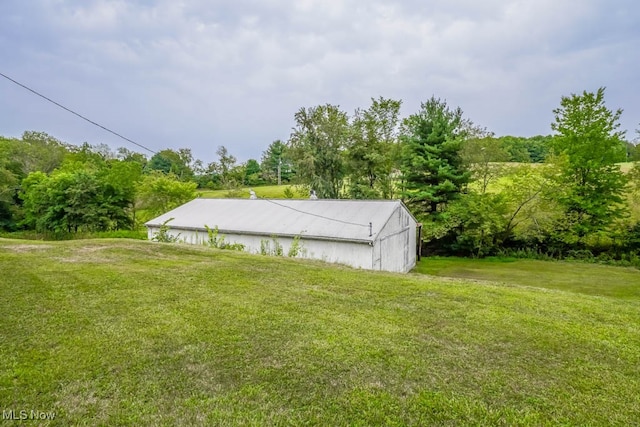 view of outdoor structure featuring a lawn