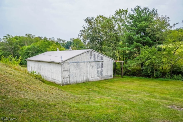 view of outbuilding with a lawn