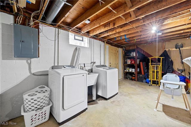 basement featuring electric panel and washer and clothes dryer