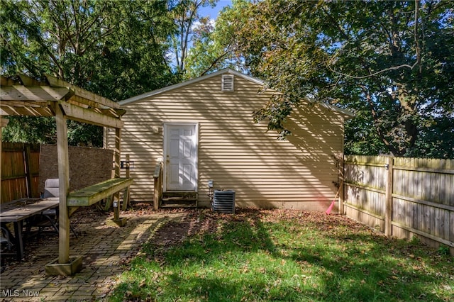 view of outbuilding featuring a pergola and central AC unit