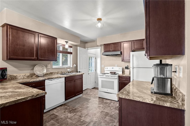 kitchen featuring sink, dark brown cabinets, light stone counters, and white appliances