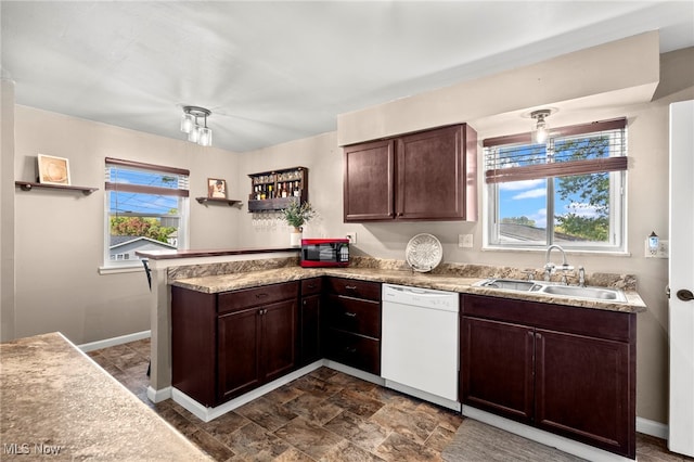 kitchen with kitchen peninsula, dark brown cabinets, sink, and white dishwasher