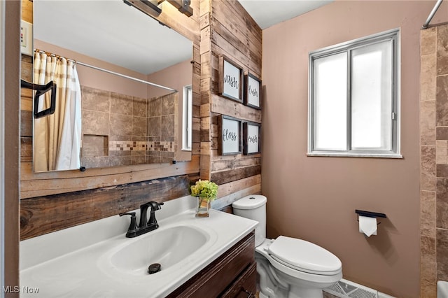 bathroom with vanity, toilet, and walk in shower