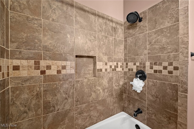 interior details featuring tiled shower / bath combo