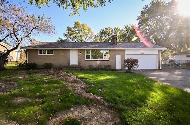 ranch-style home with a front lawn and a garage