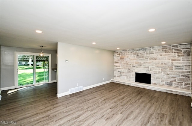 unfurnished living room with hardwood / wood-style flooring and a fireplace