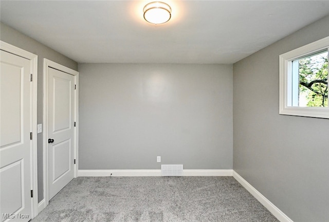 empty room with light colored carpet