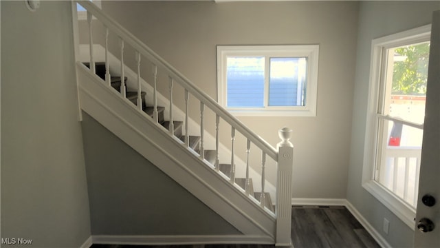 stairs featuring hardwood / wood-style floors