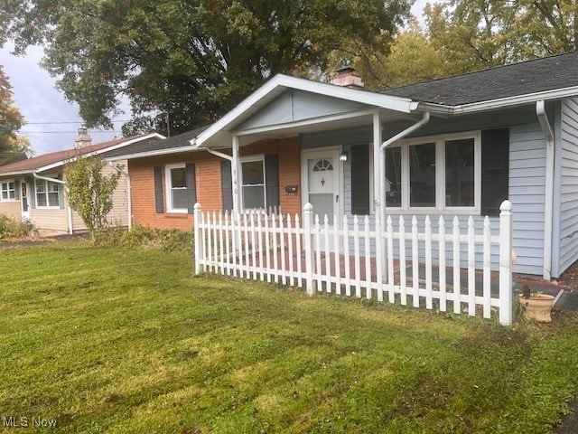 ranch-style home with a porch and a front lawn