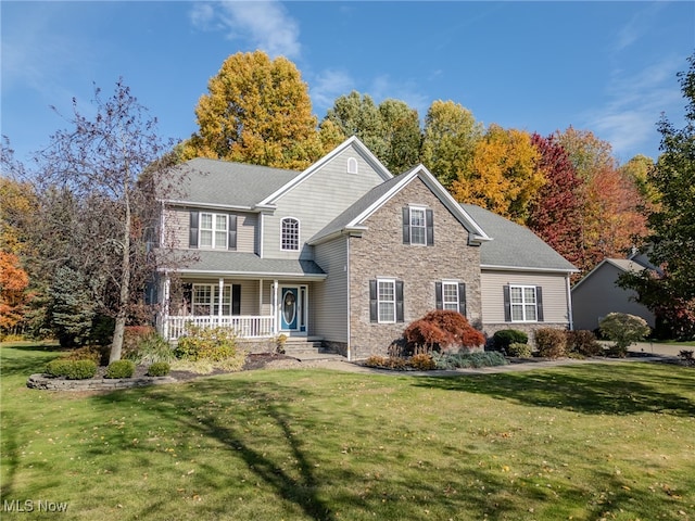 front facade with a front yard and covered porch