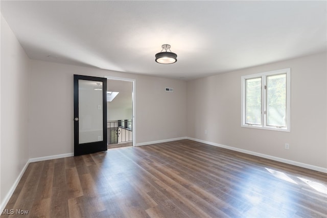 empty room with dark hardwood / wood-style floors