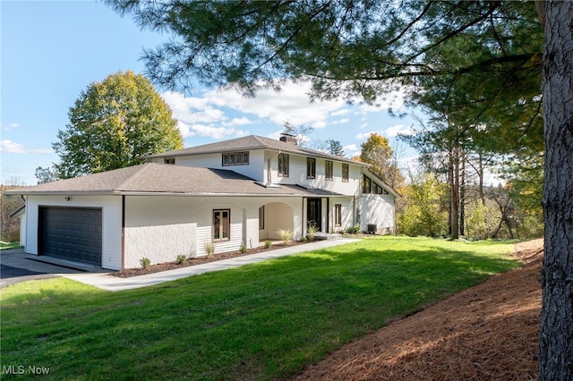 view of front of home with a front yard and a garage