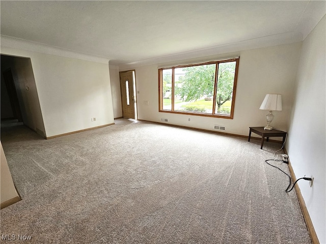 empty room with carpet flooring and ornamental molding