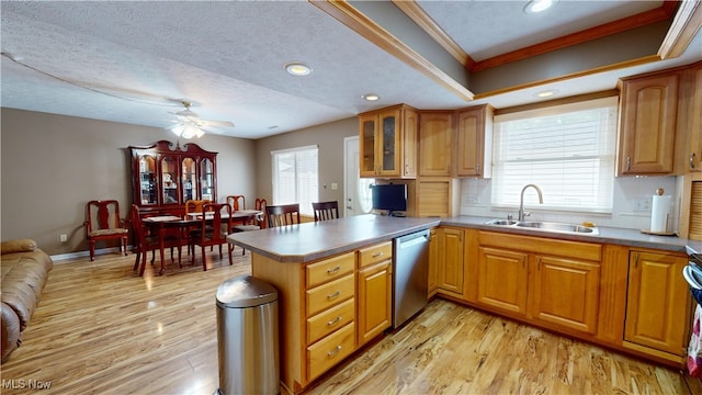 kitchen with dishwasher, light hardwood / wood-style floors, a textured ceiling, and sink