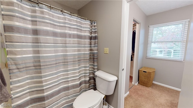 bathroom featuring a textured ceiling and toilet