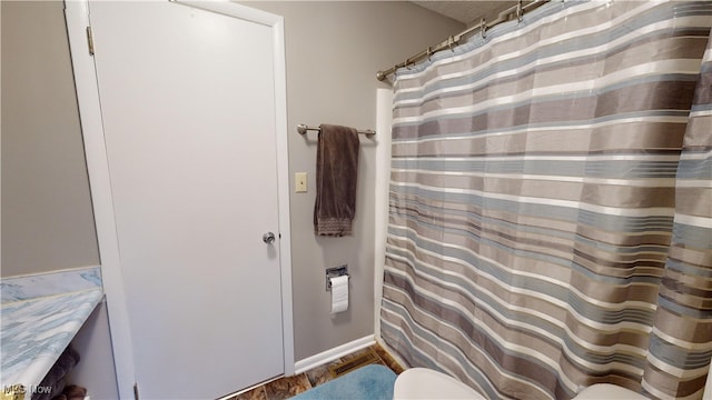 bathroom featuring wood-type flooring, vanity, and toilet