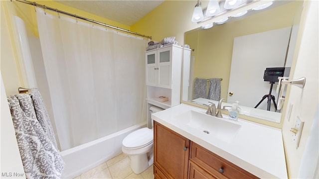 full bathroom featuring toilet, vanity, tile patterned floors, and shower / bath combo with shower curtain