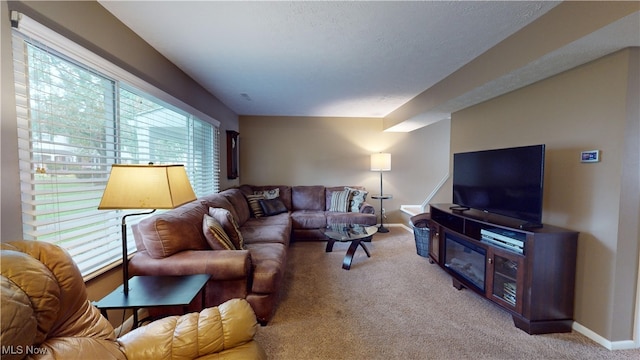 living room featuring plenty of natural light and light carpet