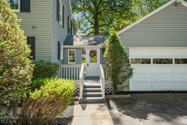 view of exterior entry with a garage