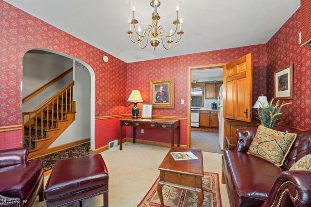 living room featuring a notable chandelier and light carpet