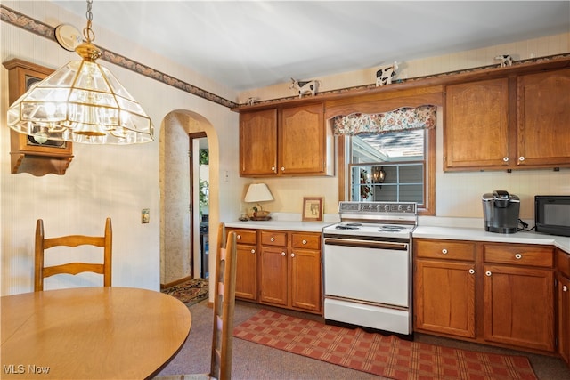 kitchen with dark carpet, hanging light fixtures, a notable chandelier, and white electric range