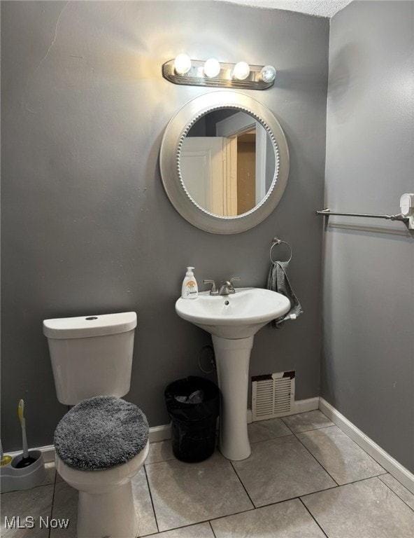 bathroom featuring tile patterned flooring and toilet