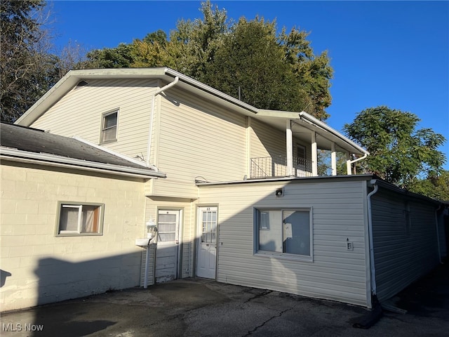 back of property featuring a balcony