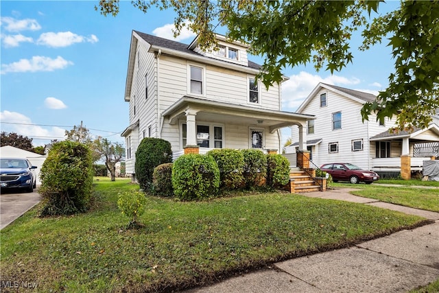 view of front of property featuring covered porch and a front lawn