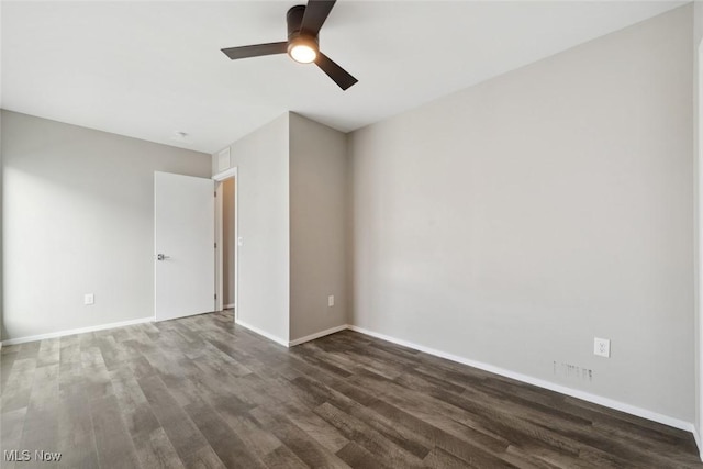 unfurnished room with wood finished floors, a ceiling fan, and baseboards